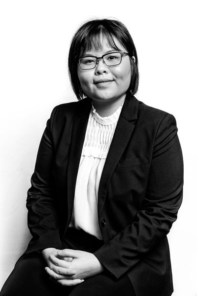 Headshot photo of Claire Wong from PCO Law sitting on a chair